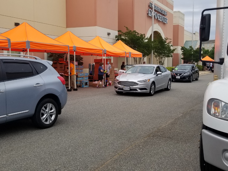 Food assistance distribution in Fredericksburg, VA Cars in line at a food assistance distribution in Fredericksburg, VA